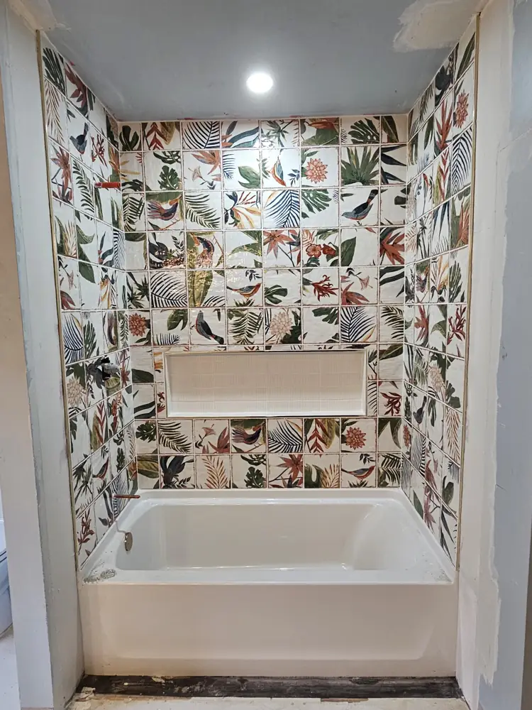 Patterned tile surround grouted with a long recessed niche