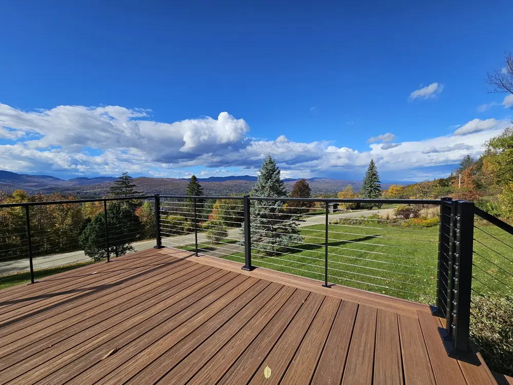 Finished Trex deck with black cable railing and mountain view