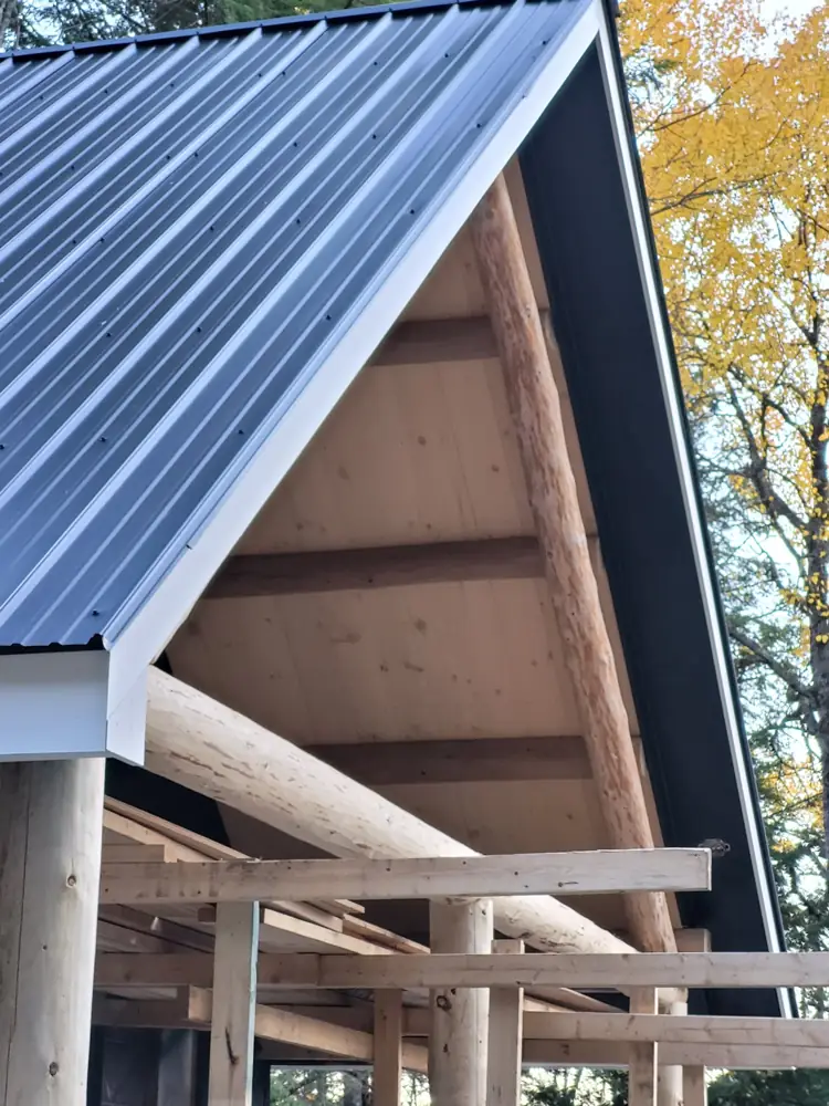 Log rafters and pine ceiling under the porch gable