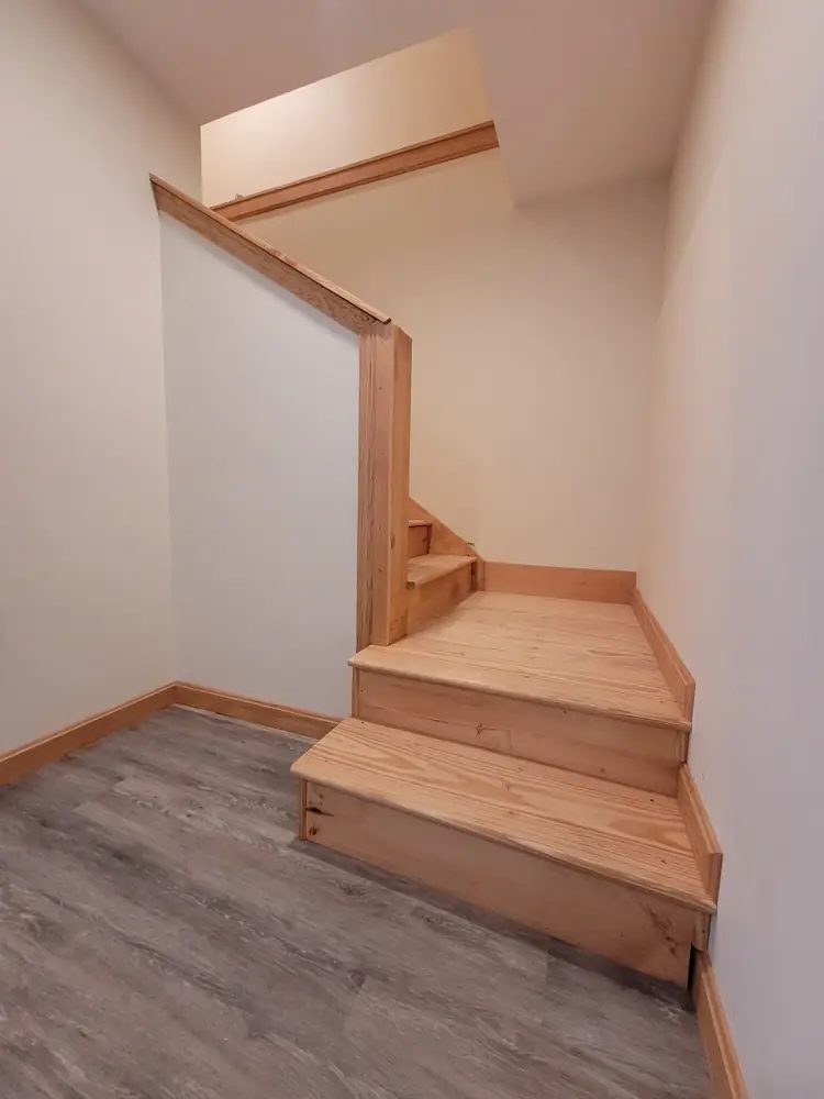 Finished pine stairs with landing, skirt boards and capped half wall