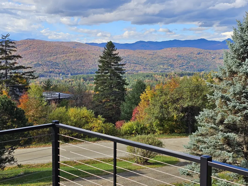Fall foliage and mountains seen over the new black cable railing